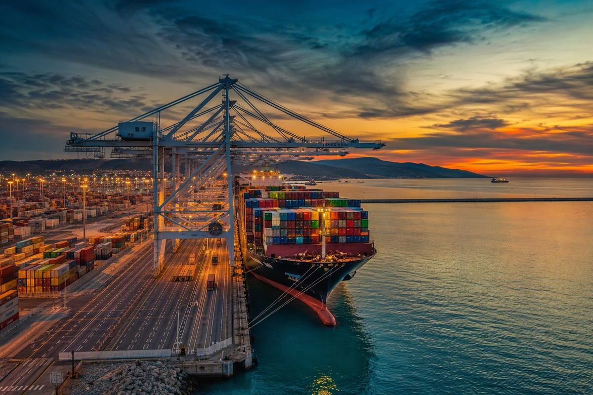 Container ship loading at a Moroccan deep-sea port at dusk